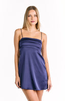 A sleeveless navy blue satin mini-dress with thin spaghetti straps and a square neckline featuring layered horizontal bands of fabric across the bust. Our dress is suitable for a semi-formal event or a party.