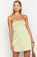 brunette model wearing a green satin mini party dress with pin tuck details at the bust