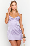 blonde model wearing a lilac satin mini dress with gathered bust details