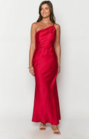 blonde model wearing a red satin one shoulder maxi dress paired with clear heels and delicate gold jewellery