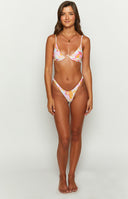 Front view of the high-leg, V-cut swim bottoms with a pink, yellow, and white wavy sun print