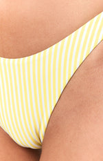 Close-up of the yellow and white vertical striped fabric of the high-cut bikini bottom