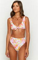 Detail shot of the pink orange and yellow sun and wave print on the bikini bottoms