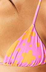 Close-up of the pink and orange floral print fabric with ruched bottom edge of the swim top cup