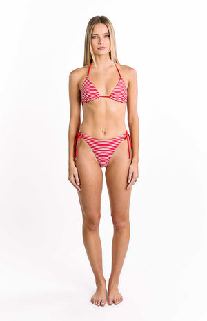 Our model wearing a simple string triangle bikini top is featured with a pattern of thin horizontal stripes in bright red and white. It has thin red string halter ties and an adjustable band at the bottom. The fit is minimal and traditional.