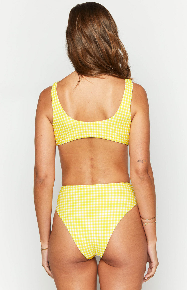 Close-up of the yellow gingham pattern and the knotted detail of the bikini top
