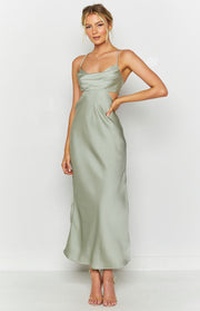 Sage green silky maxi dress with a draped cowl neckline, thin spaghetti straps, and side waist cutouts