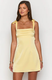 Yellow mini dress with square neckline, tie shoulders, and pleated bodice detail