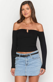 Black ribbed knit off-shoulder long sleeve top with a small bust cutout and gold ring detail