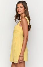 Side view of a yellow chiffon mini dress showing the square neckline, ruched bust, and side drawstring detail