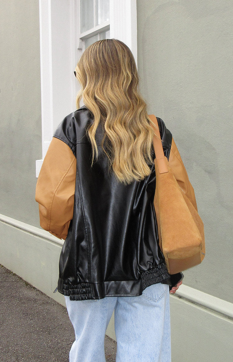 Rear view of a black and brown contrast PU bomber jacket with an elasticated ruched hem