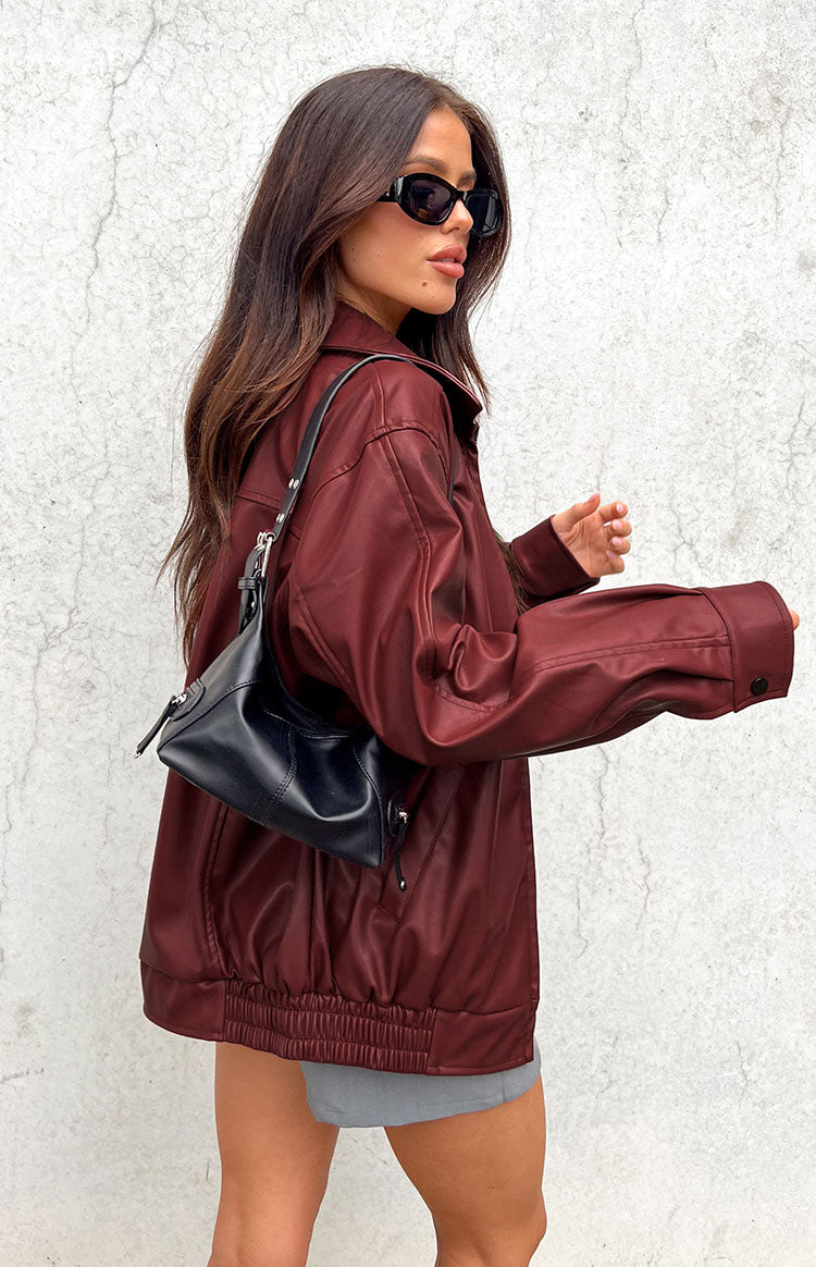 Front view of a red PU bomber jacket, worn open, showing its relaxed fit and textured material