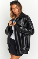Close-up of the oversized black PU bomber jacket with a wide collar, zipper, and ribbed hem