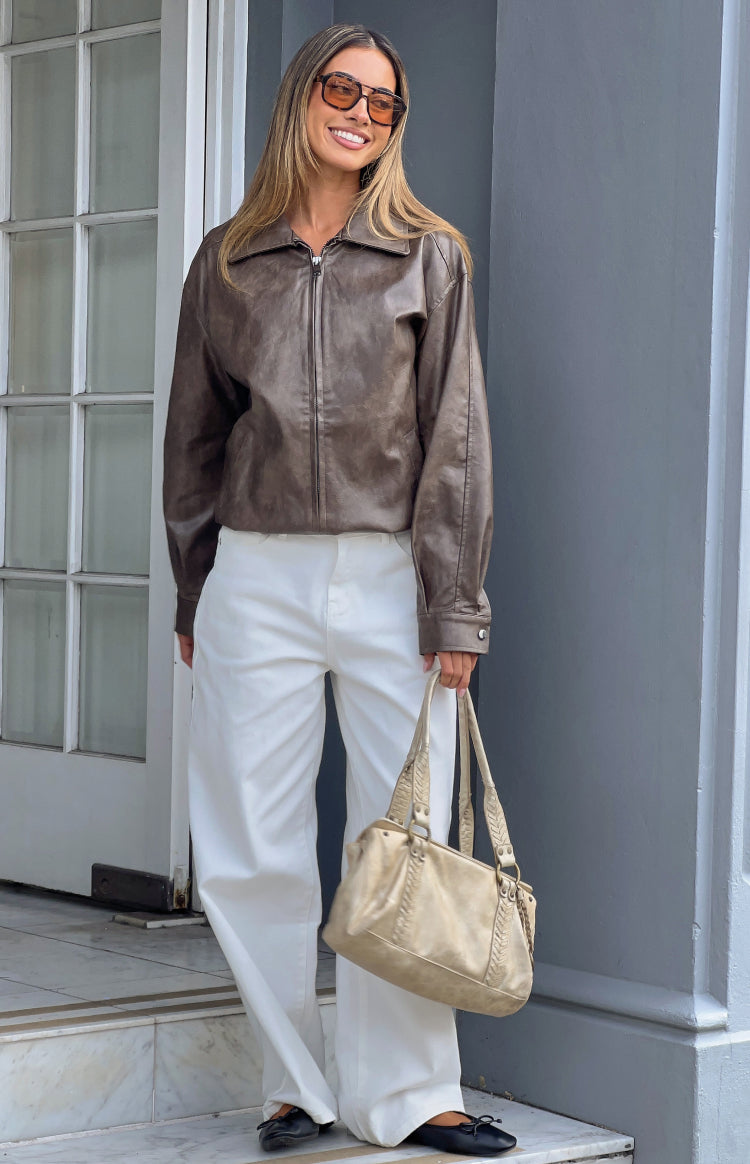 Vintage brown PU bomber jacket with a relaxed fit, classic collar, full zip front, and buttoned cuffs