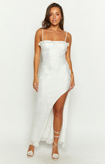White textured maxi dress with a ruffled straight neckline and a high leg split