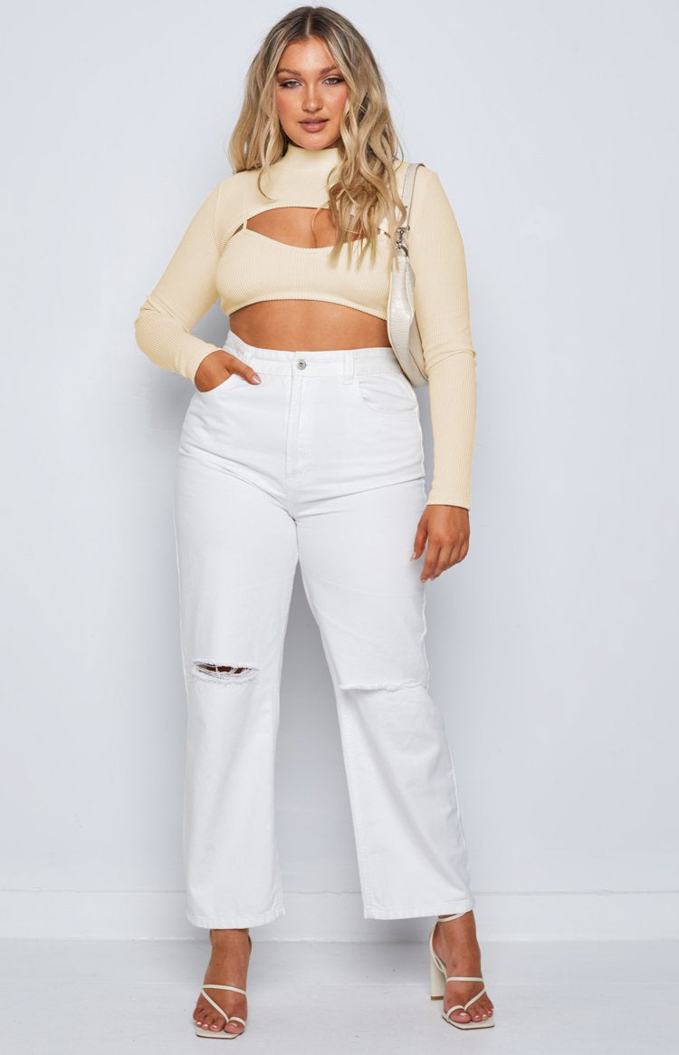 Cream ribbed knit crop top with a high neck shrug and long sleeves over a matching bralette