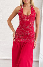 Red halter maxi dress with intricate red and silver beadwork on the bodice and a flowing skirt