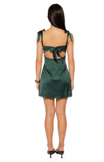 Emerald green satin mini dress from the back, featuring a tie-back closure, open back cutouts, and shoulder ties