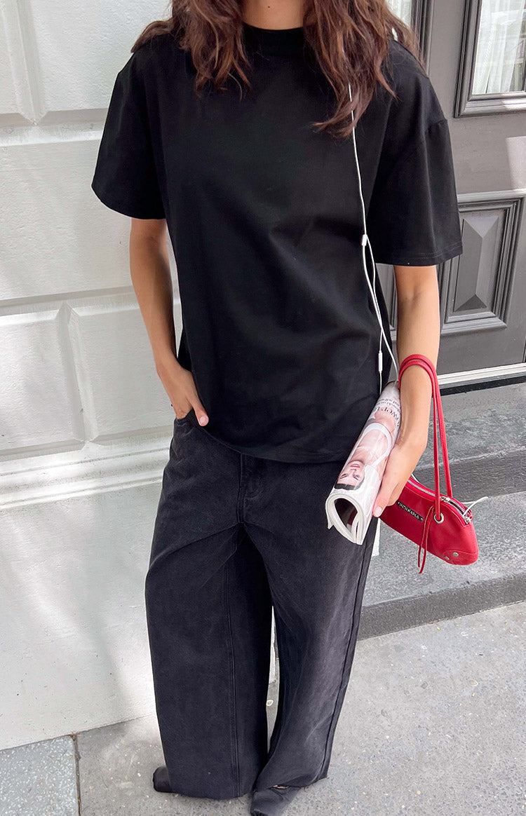 Front view of a black crew neck tee with relaxed fit and short, wide sleeves