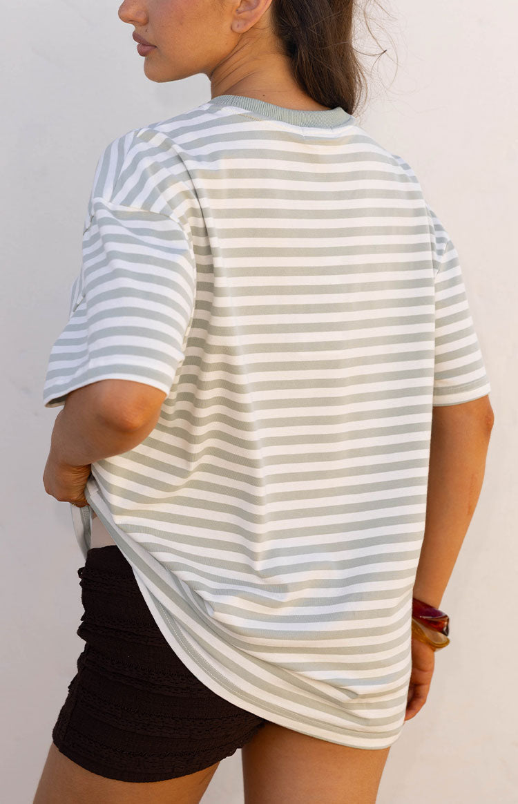 Rear view of the sage and white striped oversized tee, showing the relaxed drape and ribbed crew neck