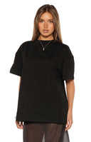 Black jersey shorts with white polka dots, a wide waistband, and a fitted, short cut