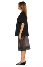 Side view showing the relaxed fit and dropped short sleeves of a black tee