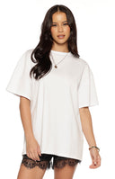 Full length view of sheer white wide-leg pants with an all-over floral lace pattern