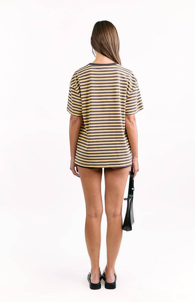Rear view of an oversized yellow and dark grey striped tee with short sleeves