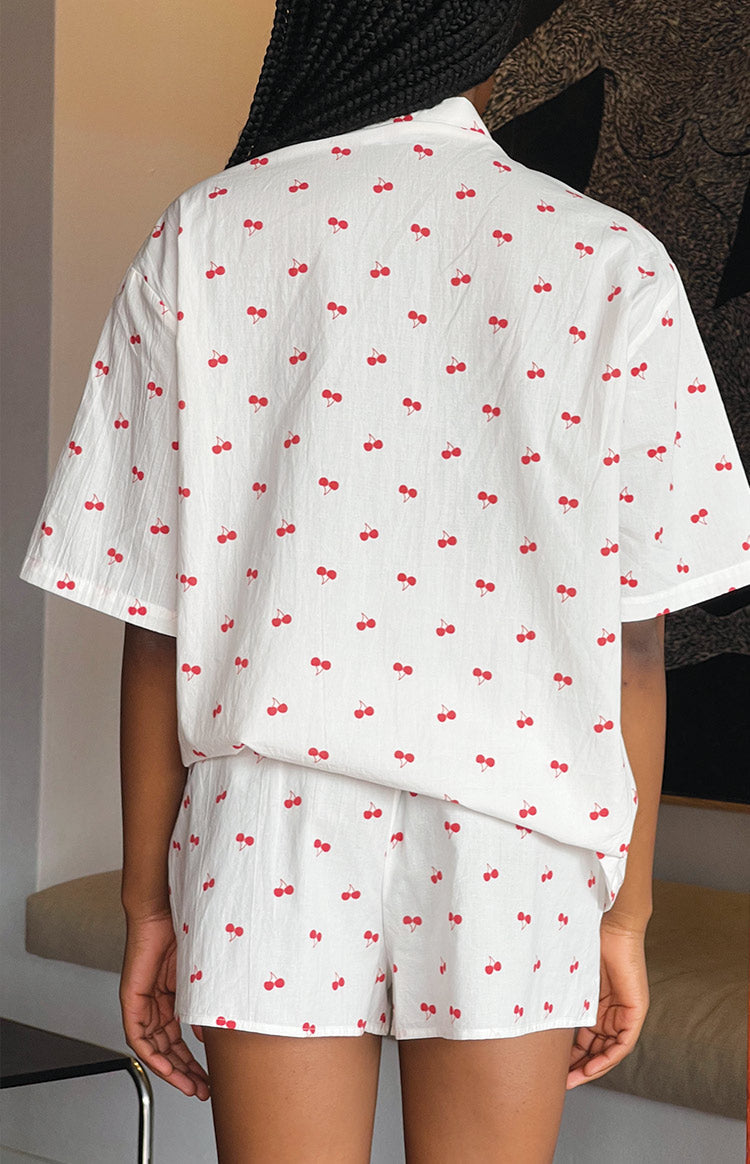 Rear view of white cherry print relaxed fit pajama shorts and matching short sleeve top