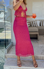 Fuchsia lace maxi skirt with adjustable tie-up sides creating a ruched waist and a delicate paisley pattern