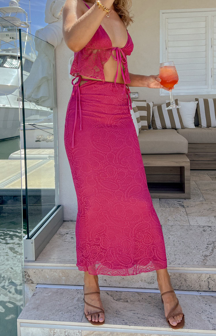 Fuchsia lace maxi skirt with adjustable tie-up sides creating a ruched waist and a delicate paisley pattern