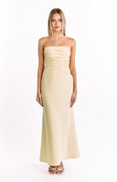 A strapless cream-colored maxi-dress with a ruched bodice and a flowing satin-like skirt that flares slightly at the bottom. Our elegant dress is suitable for a formal event.