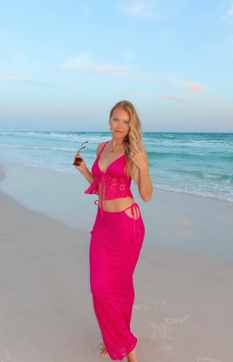 Fuschia lace maxi skirt with side tie-up waist cutouts and a fitted silhouette