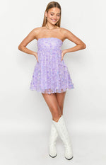 Front view of a purple strapless mini dress with 3D floral appliques and iridescent sequins
