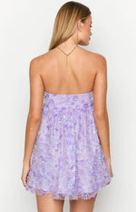 Rear view of a strapless lilac mini dress covered in delicate 3D floral appliques and sparkling sequins