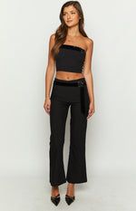 Black strapless crop top with a velvet trim along the top edge and an O-ring detail with a velvet strap