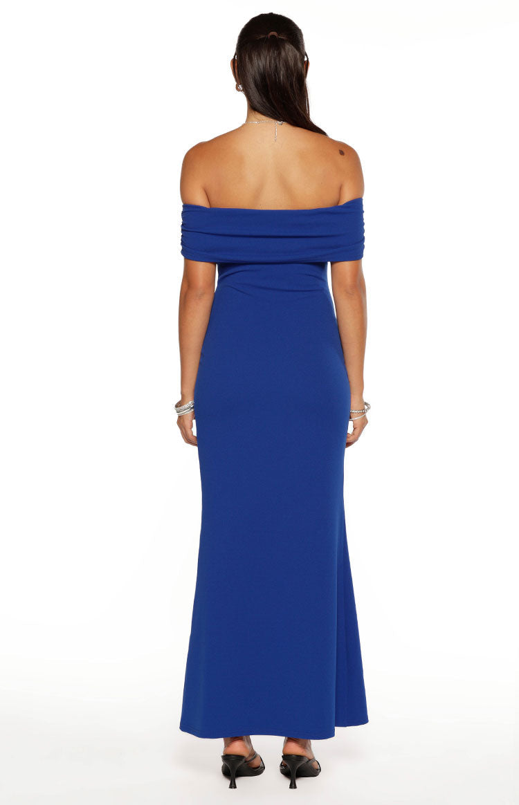 Rear view of a cobalt blue crepe maxi dress with a draped off-shoulder neckline and a fitted silhouette
