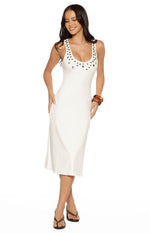 White scoop neck midi dress with silver stud details on the neckline and straps, fitted bodice and raw hem