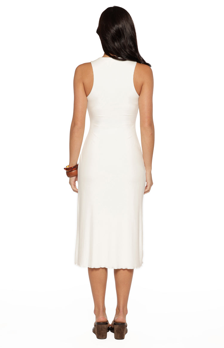 Rear view of a white sleeveless midi dress with a high round back and a fitted silhouette in a soft knit