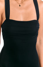 Close-up of the black mesh ruched bodice with wide gathered straps of a formal maxi dress