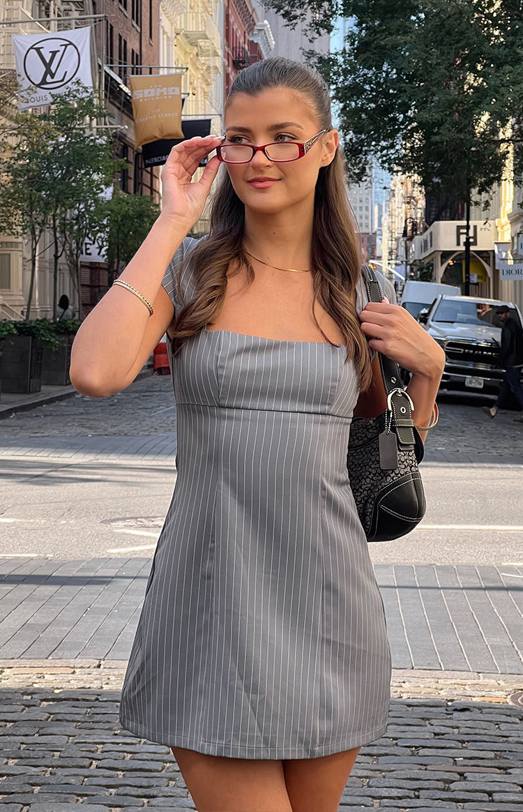 Front view of a grey pinstripe mini dress with a square neckline and short cap sleeves