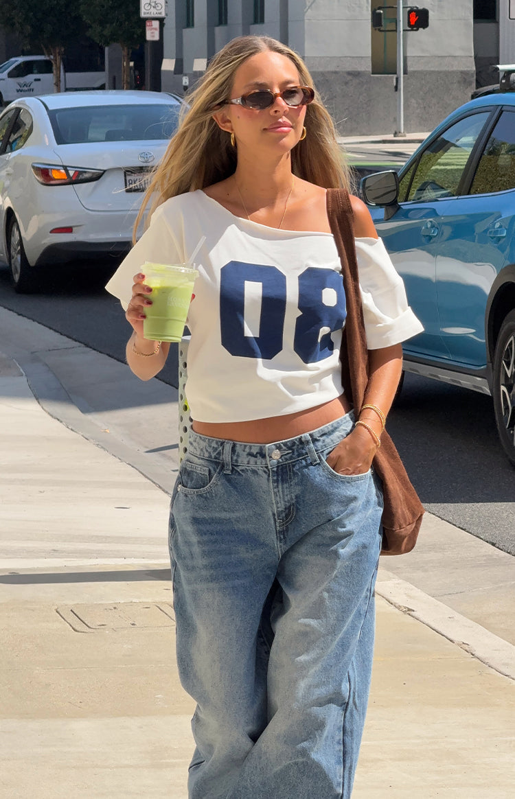 Cropped white off-shoulder oversized tee with navy '08' print and cuffed short sleeves