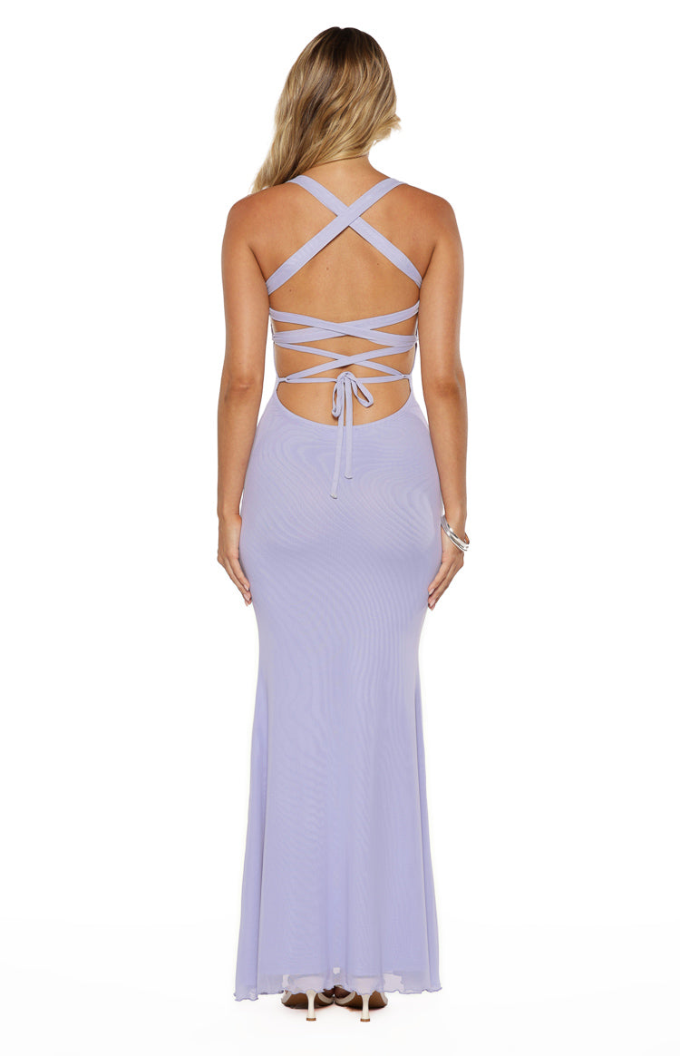 Rear view of a lilac mesh maxi dress with criss-cross back straps, a tie-up detail, lower back cutout, and scalloped hem