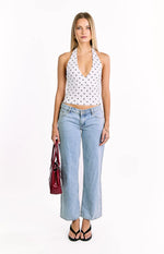 White polka dot crop top with a deep V-neck halter neckline and fitted silhouette