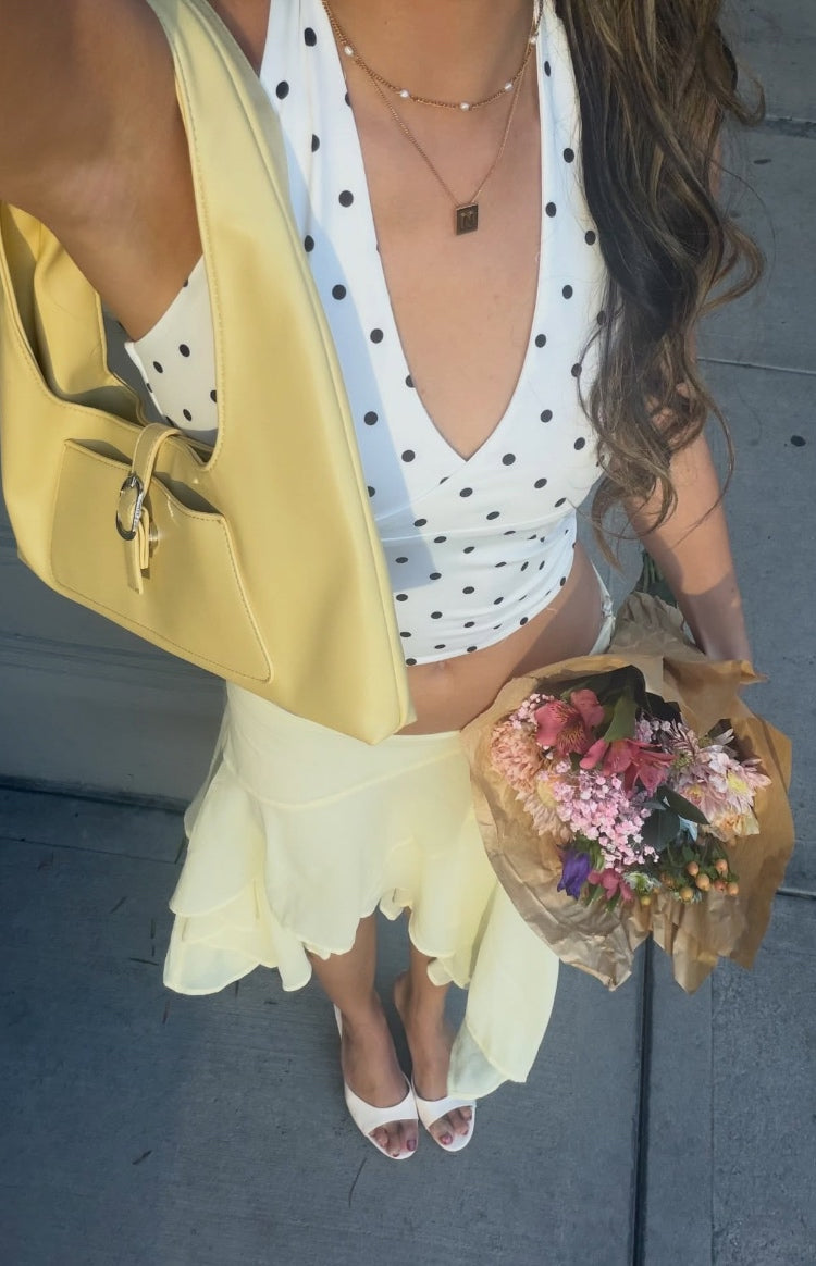 White polka dot crop top with a deep V-neckline and cropped hem
