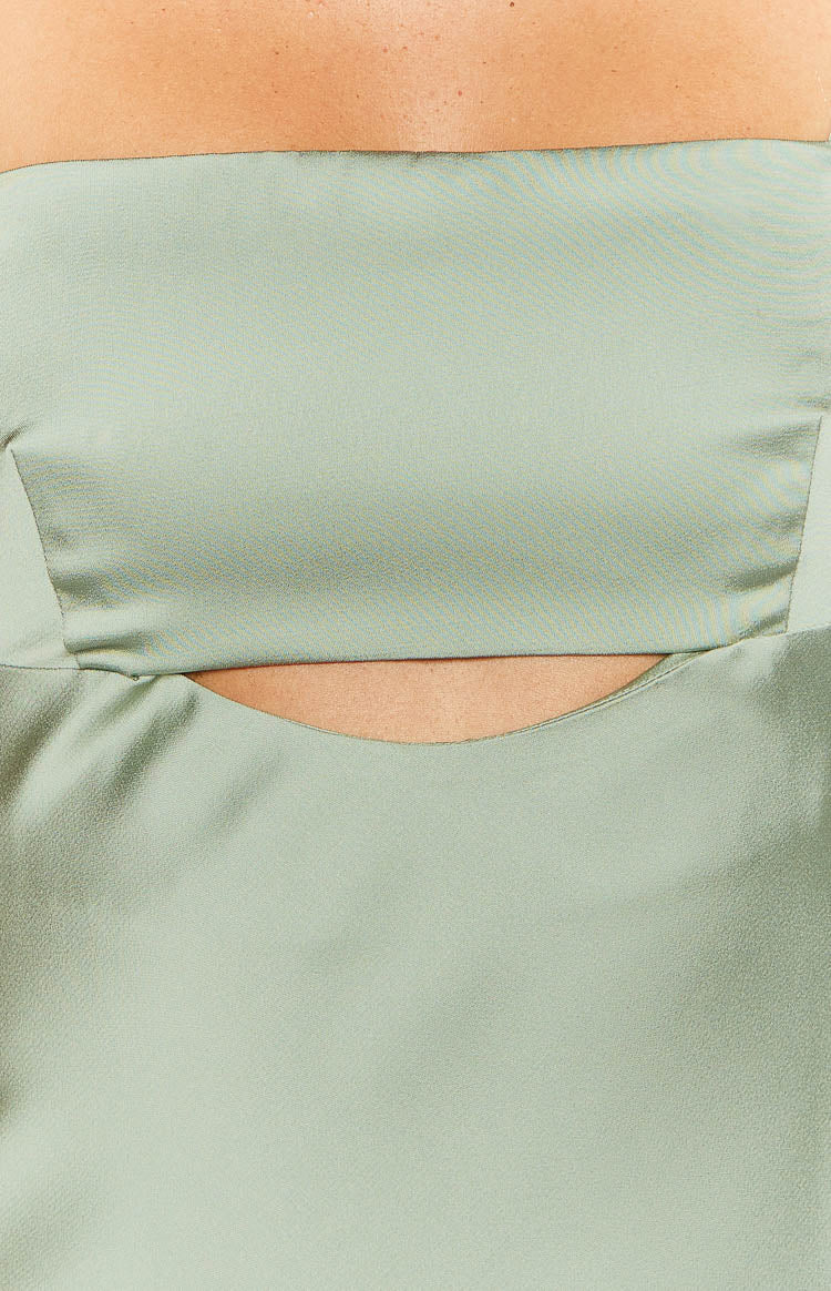 Close-up of the sage satin maxi dress with a curved cutout detail at the midriff