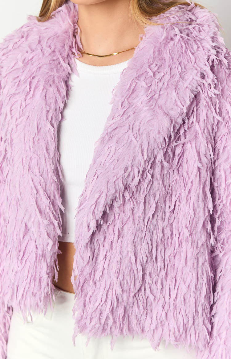 Close-up of the purple fringe jacket's textured fabric and open front