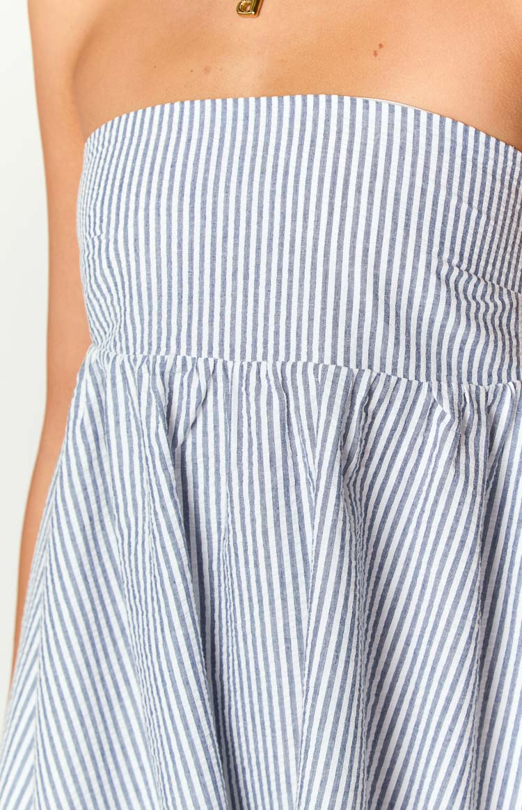 Close-up of the blue and white stripe strapless mini dress showing the gathered waist and textured fabric