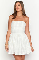 White strapless mini dress with a ruched bodice and sheer square textured fabric
