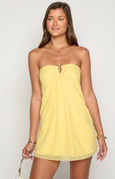 blonde model wearing a strapless yellow mini dress with a gold u bar detail at the bust